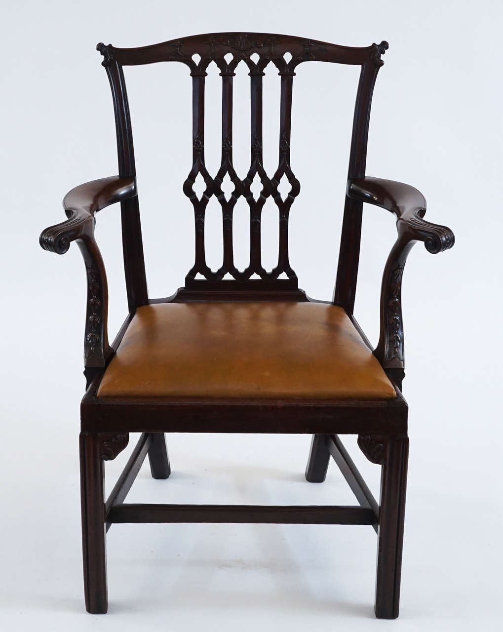 Fine English George III period, circa 1770 carved mahogany armchair in Thomas Chippendale 'Gothick' manner having a serpentine crest-rail carved with acanthus 'ears' and centre foliate motifs surmounting an open-carved back-splat with central cusped