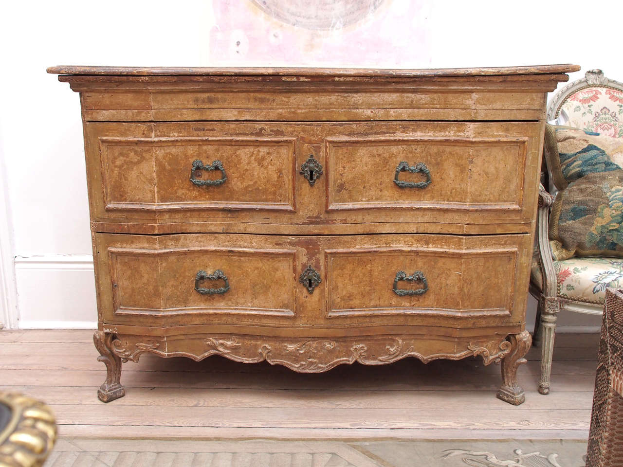 This wooden commode was made during the 18th century in France.  The wood has lots of marks on it, especially the top of it.  The knicks and marks add to its charm and reveal its authenticity.