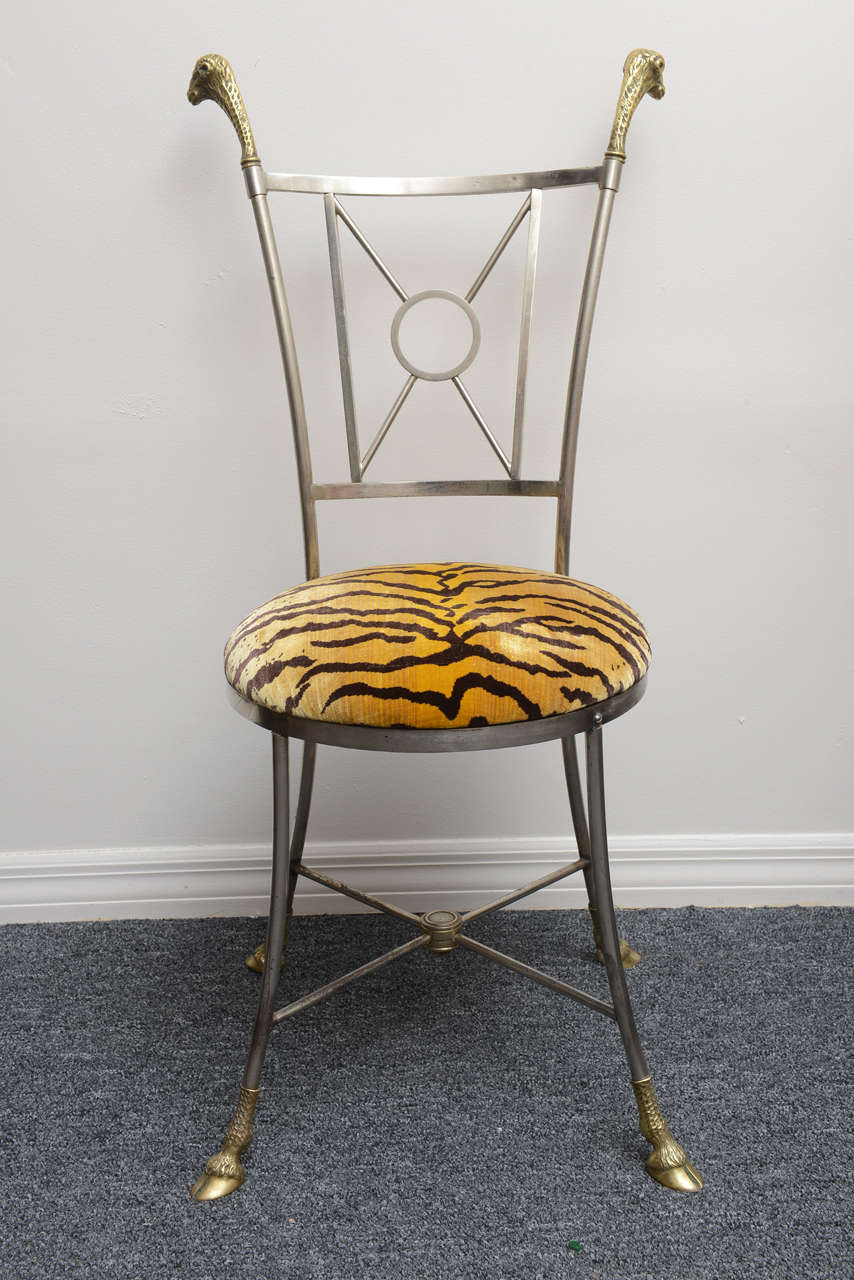 Rare Jansen style chair of brushed steal and brass with ram's mask and hoofed feet.
Upholstered in tiger fabric.