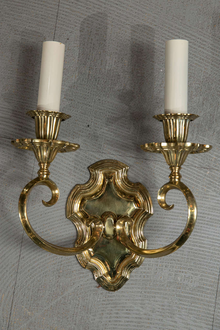 A pair of gilt bronze Caldwell sconces, with unusual scrolled arms, circa 1920s. Will be newly wired upon purchase.