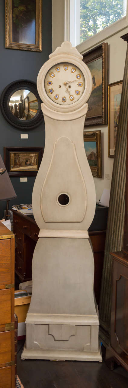 Early 19th c Swedish painted long case, bell chime clock. A streamlined Baroque revival design with cream and gray brown paint. Composed of three pieces: a base, case with door, and bonnet. Excellent 8 day works with the old pendulum and weights,