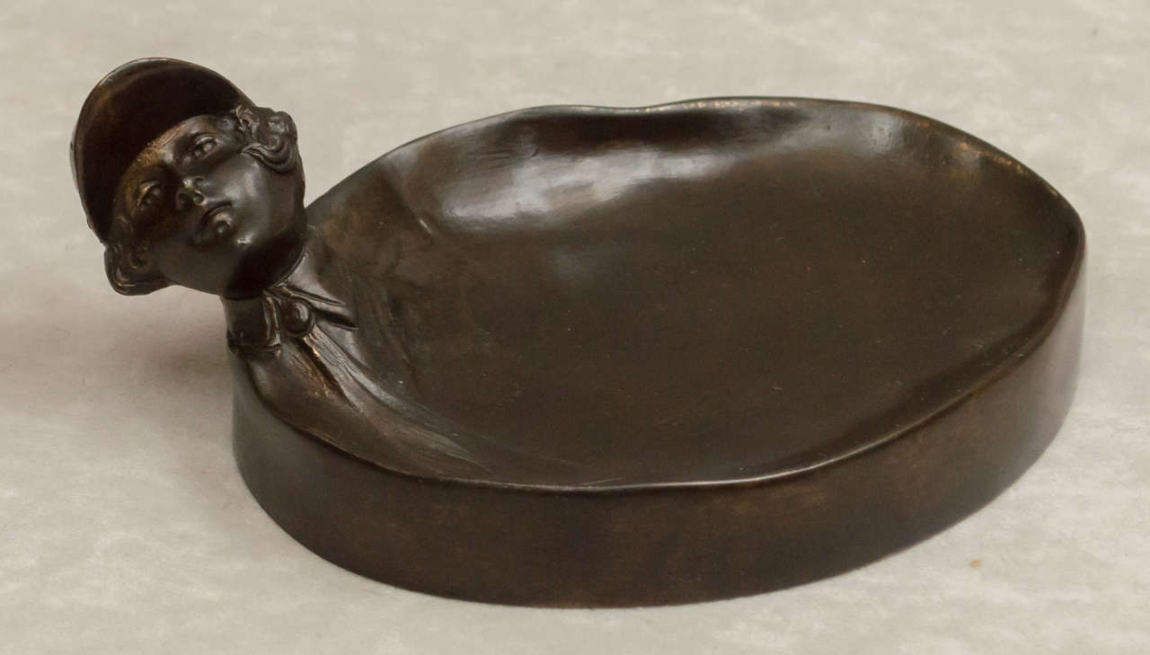 This very unusual bronze is a lovely casting on both top and bottom. What a nice surprise when turned upside down revealing an erotic scene. We believe this bronze was done by the great art deco sculptor Bruno Zach. It certainly has his look and