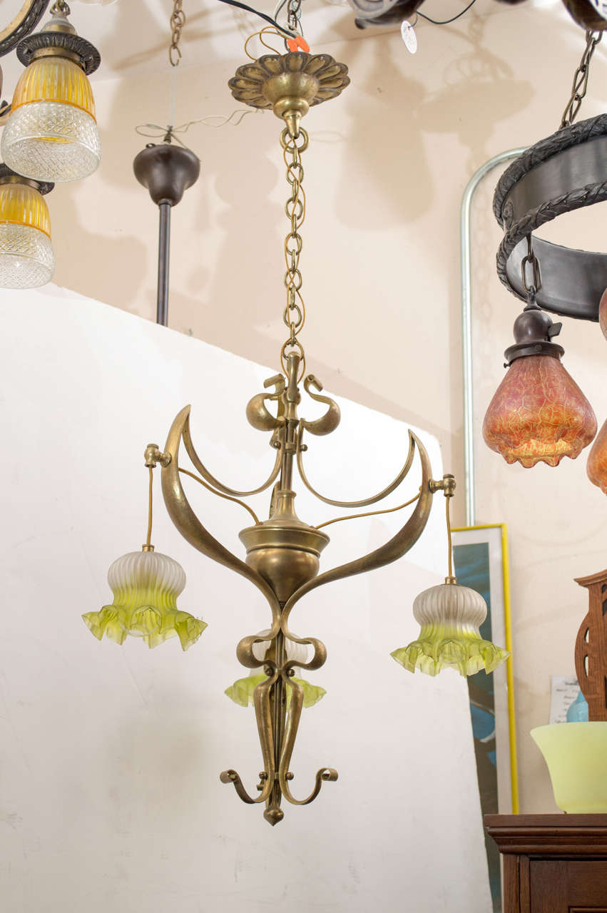 Please look at how graceful this little gem hangs from a ceiling. Nice original aged gold patina and all the original glass shades, which in the lighting game is rare indeed. A perfect smaller fixture for any room. Also has the original ceiling