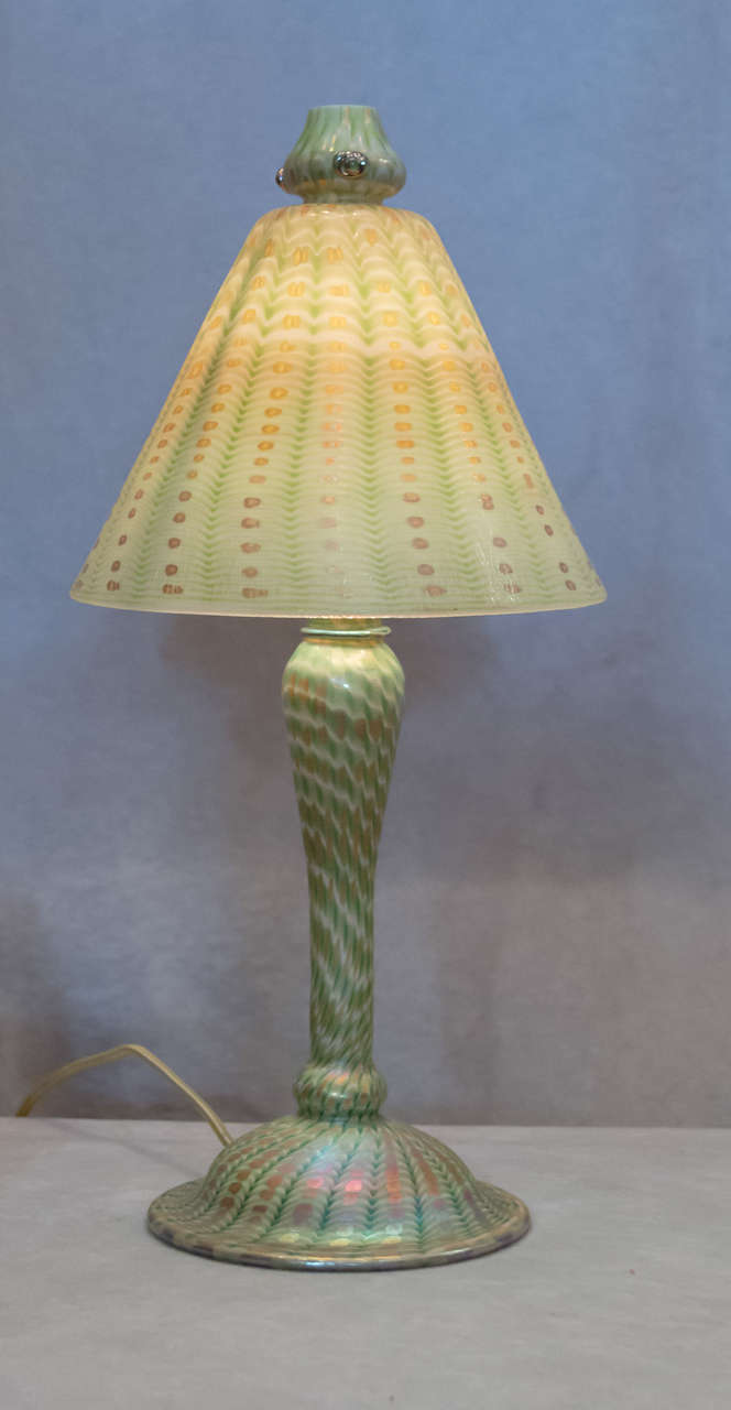 If you want a fine example of a Tiffany Studios Lamp,we are offering one right here. All glass,and a beautiful pattern show what a genius this man exhibited in his works. You may find a shade or a base to this lamp,but here we have the entire