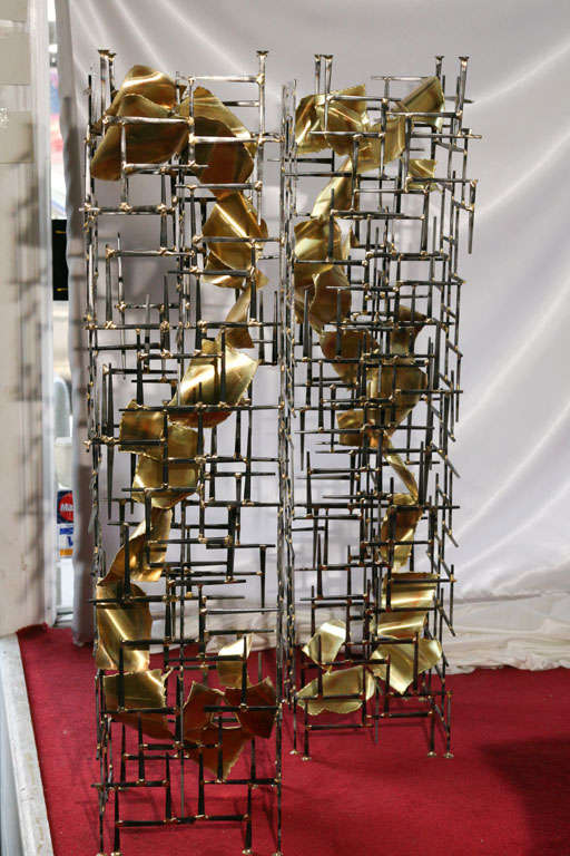 A pair of original One-of-a-kind metal sculpture Pedestals by Lou Blass in steel and Bronze. each one similar but reverse of each other. Each has a 12" by 12" by 1/2" Glass top.
The entire collection of licensed Lou Blass Sculptures