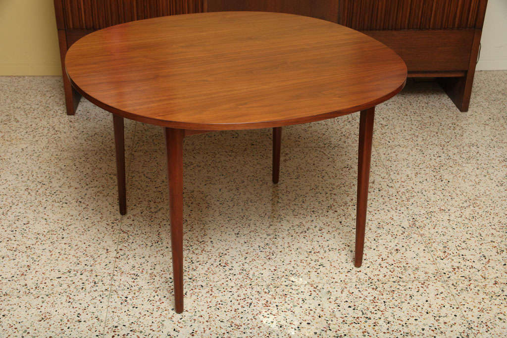 SOLD MAY 2011 For Drexel and the Declaration Line, Stuart MacDougall & Kipp Stewart designed this beautifully figured walnut dining table with rich tapering solid walnut legs and skirt that expands with two leafs, each 22