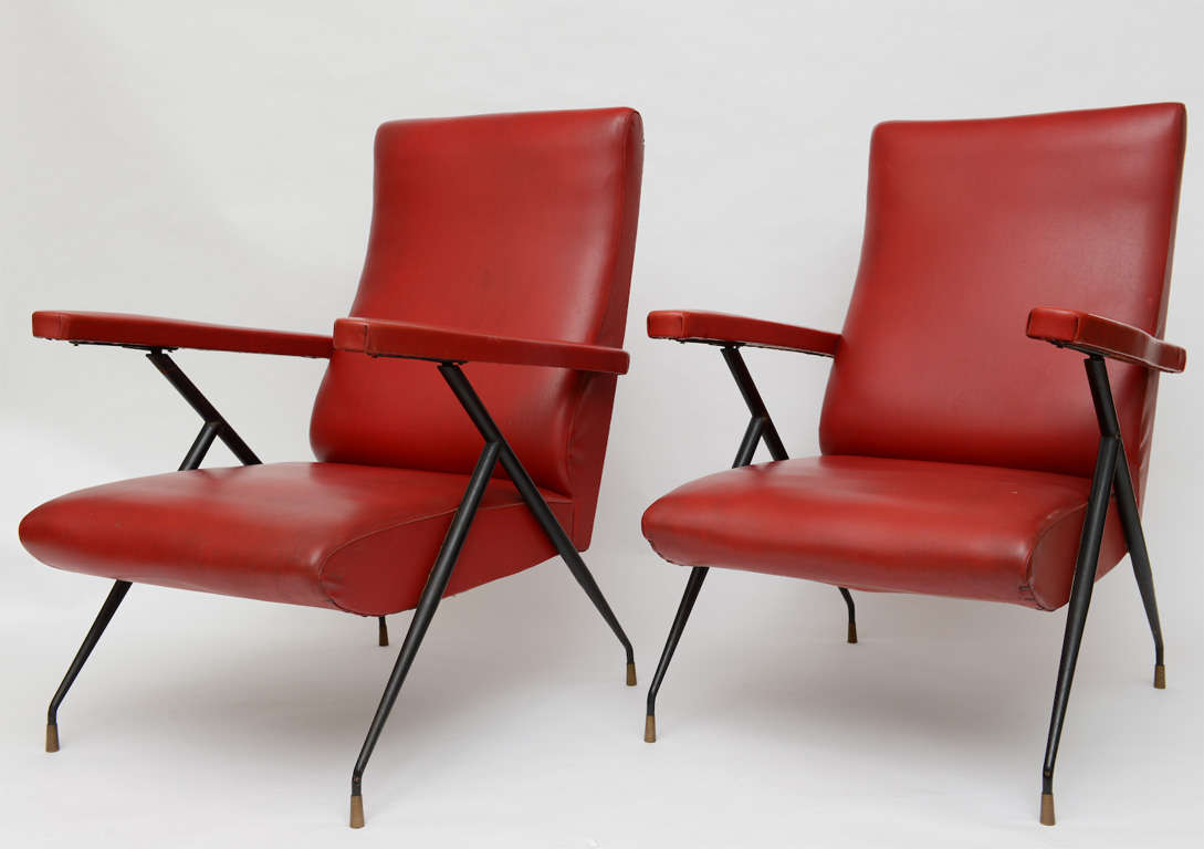 All original pair of Italian adjustable chairs. Metal frame in black with brass sabots. Naugahyde upholstery in red.