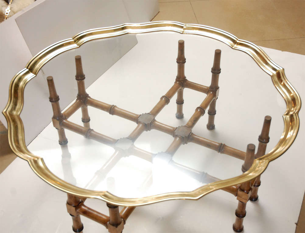 Brass framed piecrust glass top table on bamboo & brass trestle base.