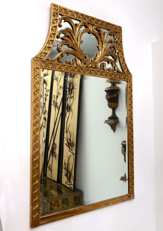 Carved and gilt wood mirror with plume motif on the upper crest.
