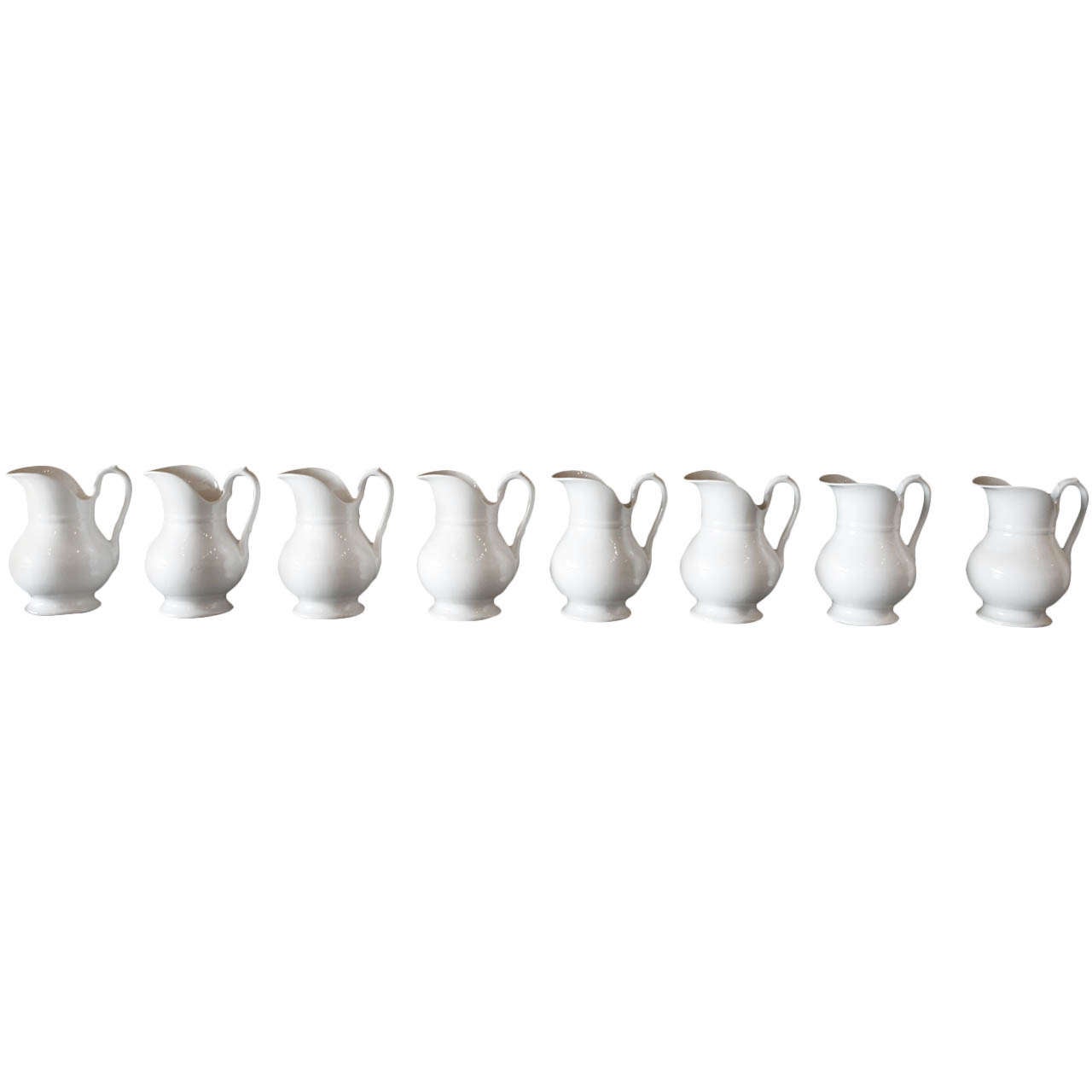 A Set of Eight Ironstone Pitchers, France