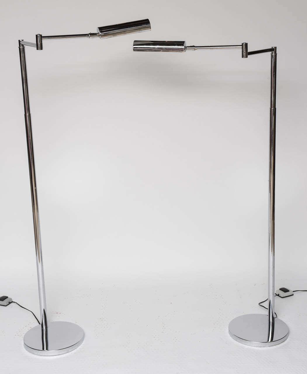Pair of Koch & Lowy polished chrome adjustable floor lamps signed OMI.