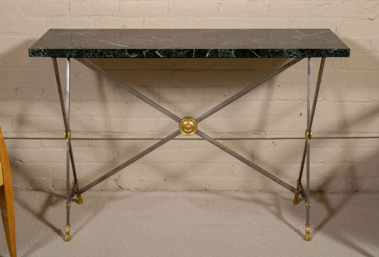 An elegant, neoclassical, steel and gilt/bronze console table with green marble top, by Maison BAGUES - France - circa 1960