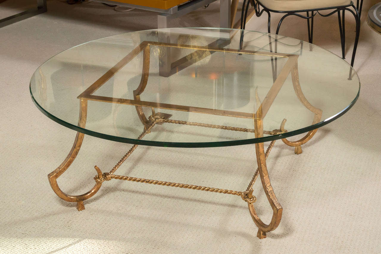 An exceptional Neoclassical gilded, wrought-iron cocktail table with round glass top by RAMSAY Decorateur.
Circa 1940 - France