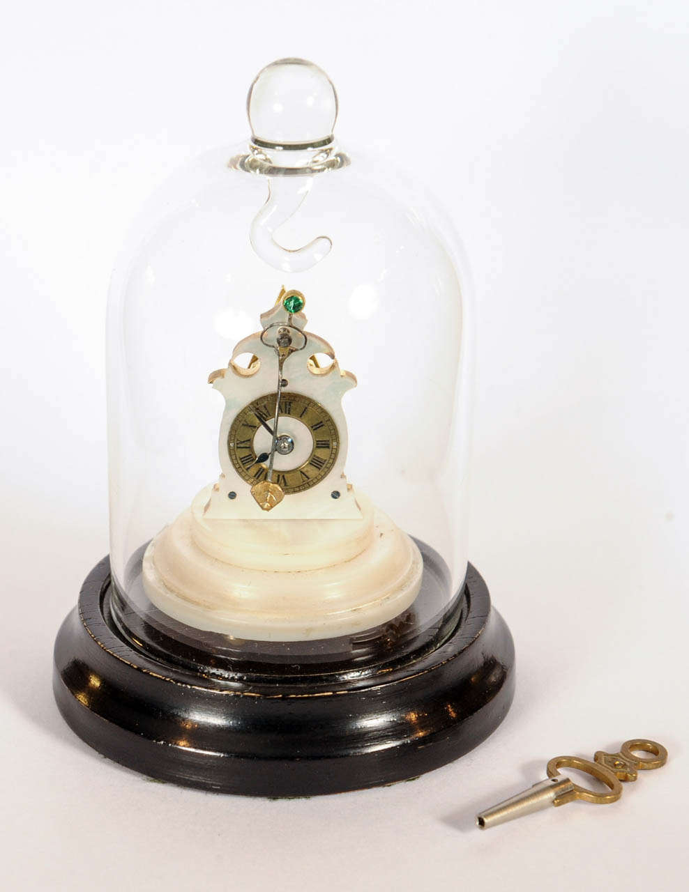 extremely small clock with dome and base.