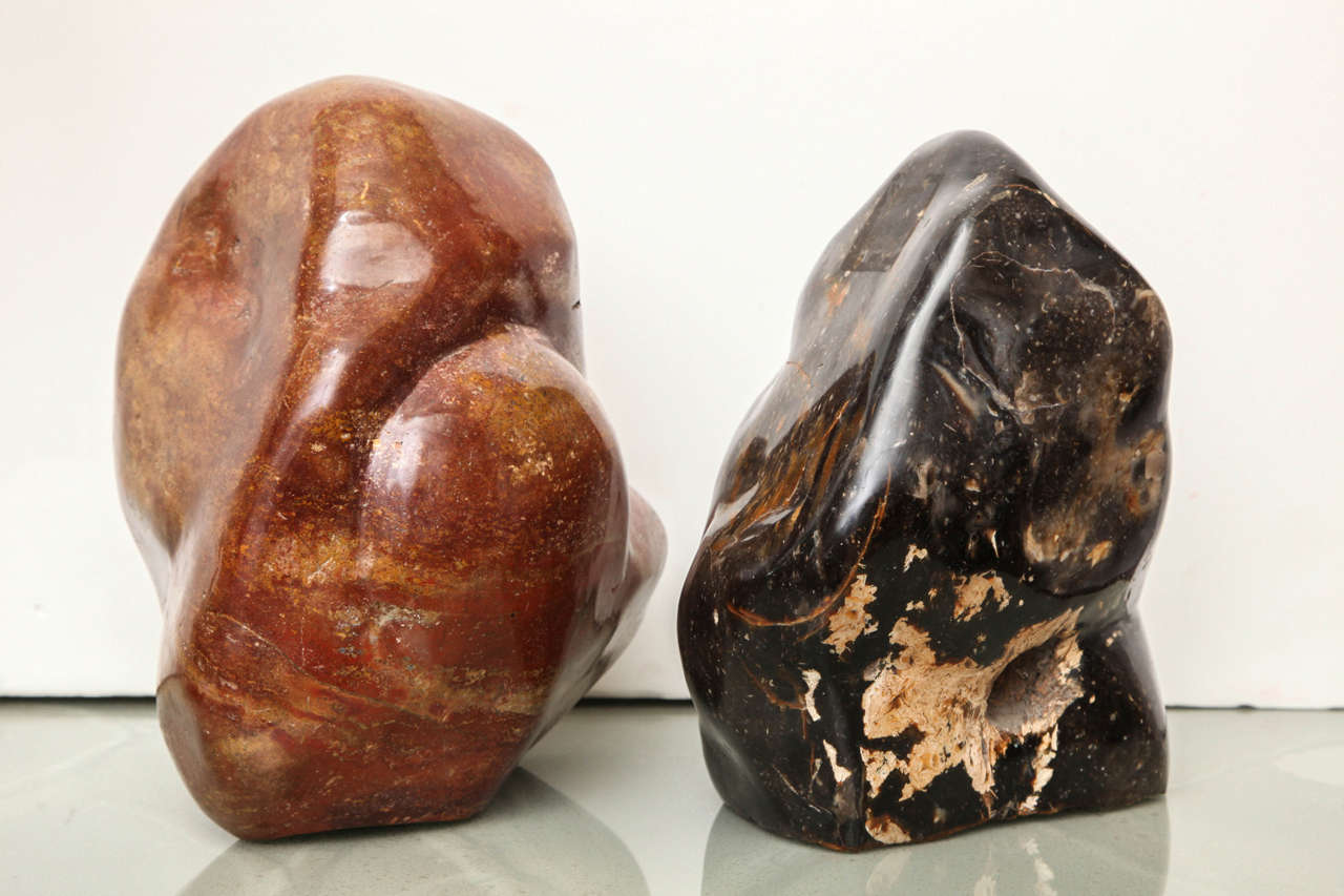 Natural sculptures. One is carnelian mineral. The other is black/gold marble. Priced and sold individually. The carnelian sculpture is approx. 8"x8"x10.5". The marble sculpture is approx. 8"x8"x12".