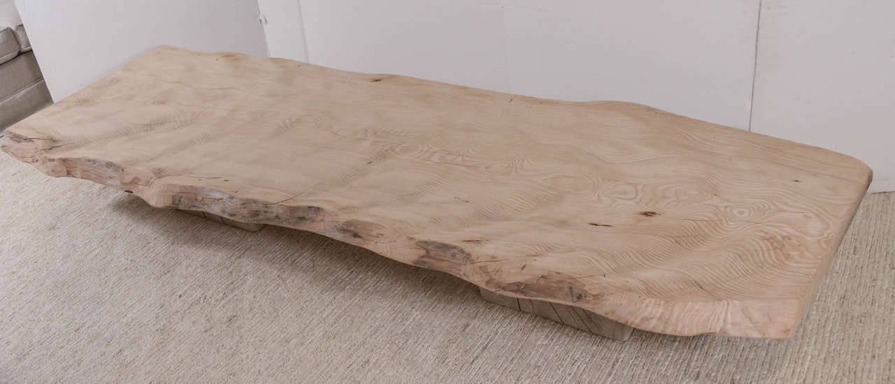 Large-scale, very organic cedar coffee table. Live edge floating on two square bases. From Belgium.