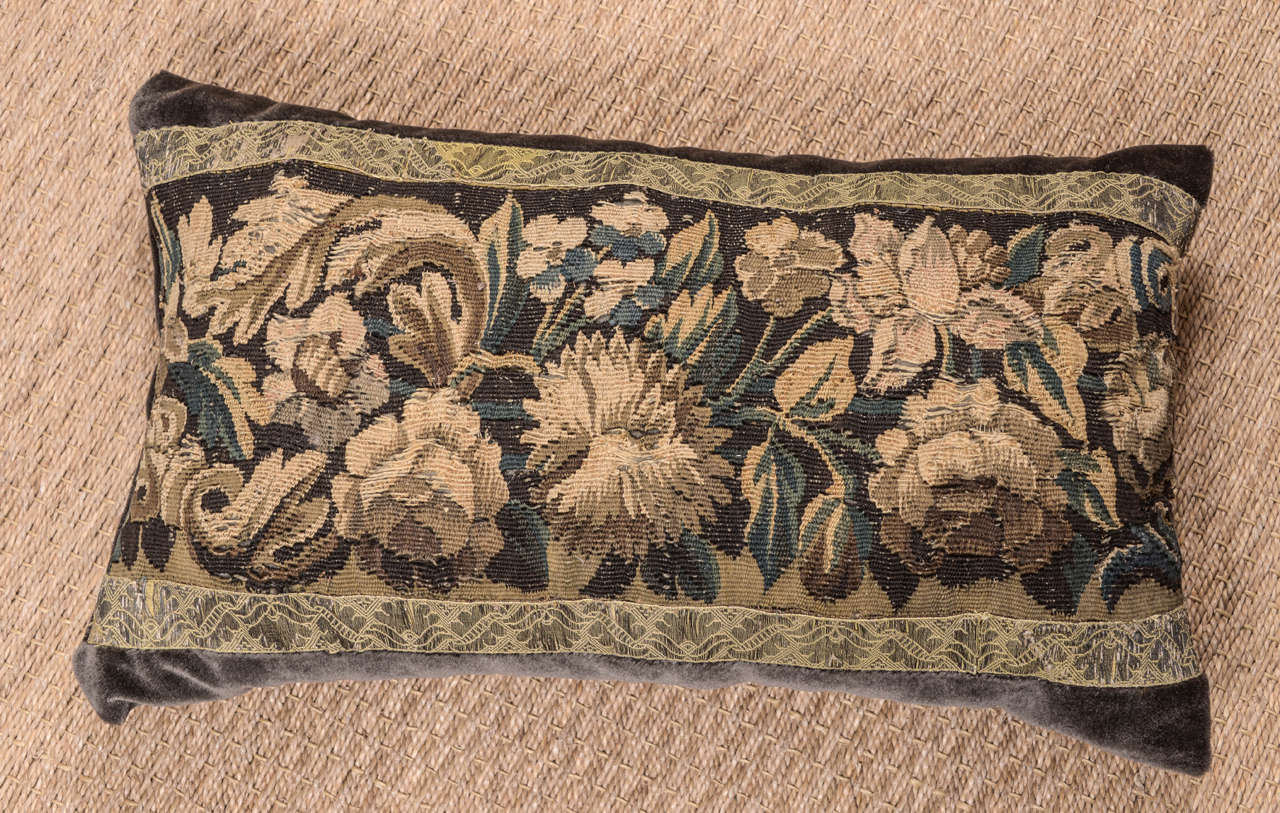 18th century large lumbar tapestry fragment pillow constructed with plush velvet in rich chocolate hue. Tapestry framed with antique French galon ribbon. Down filled.

Custom-made using 18th century tapestry.