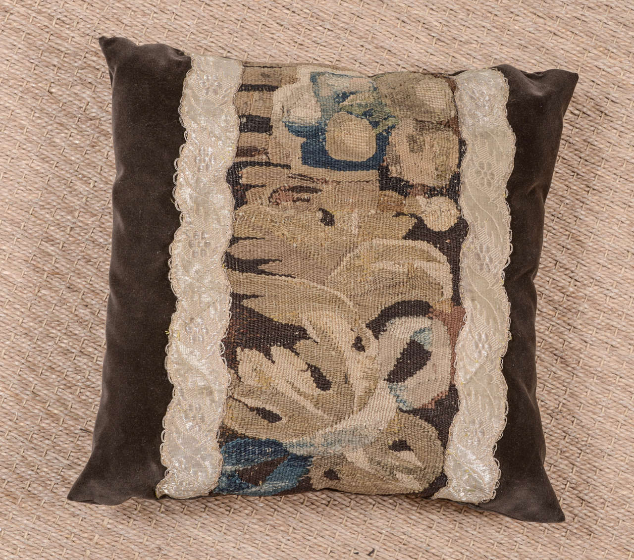 18th century tapestry fragment pillow constructed in 100% cotton velvet in rich chocolate hue. Tapestry is framed with French Galon. Down filled.