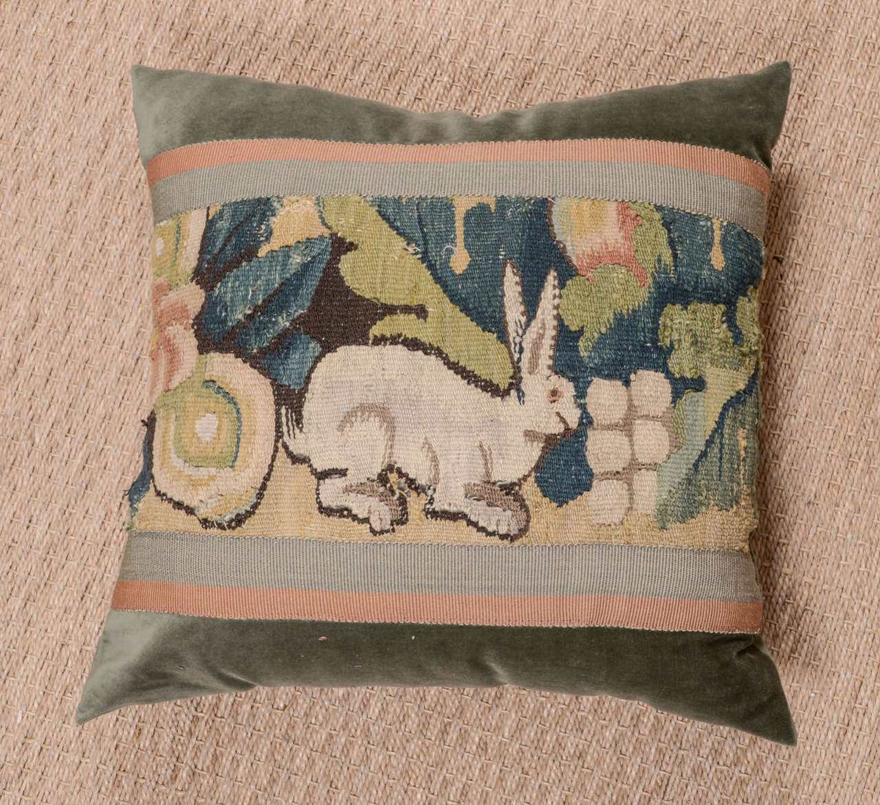 Antique tapestry fragment pillow constructed using celadon velvet. Tapestry is framed with a rose and taupe ribbons. Down filled.