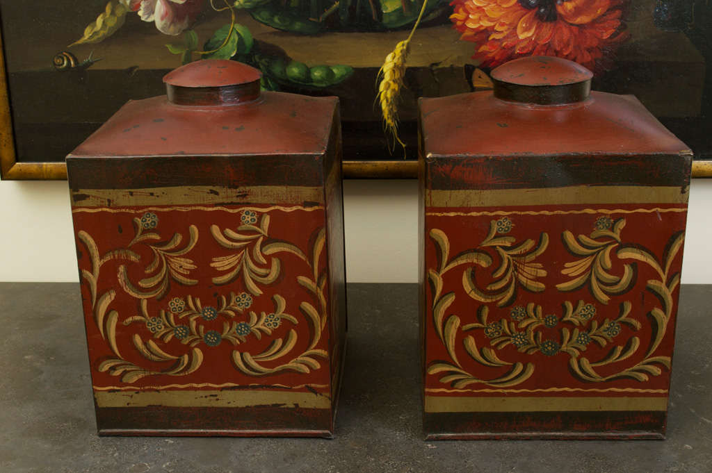 A pair of painted and decorated tin Dutch cocoa containers