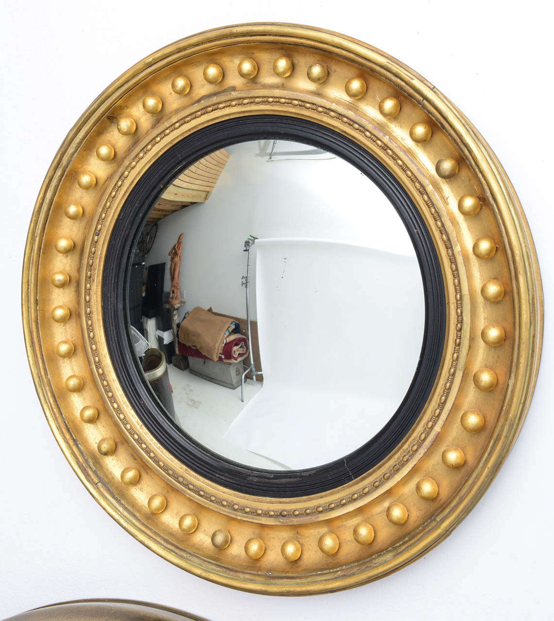 Late 19th century gilt-wood Regency style convex mirror.
 
Note:   Overall diameter of frame is 27 3/4