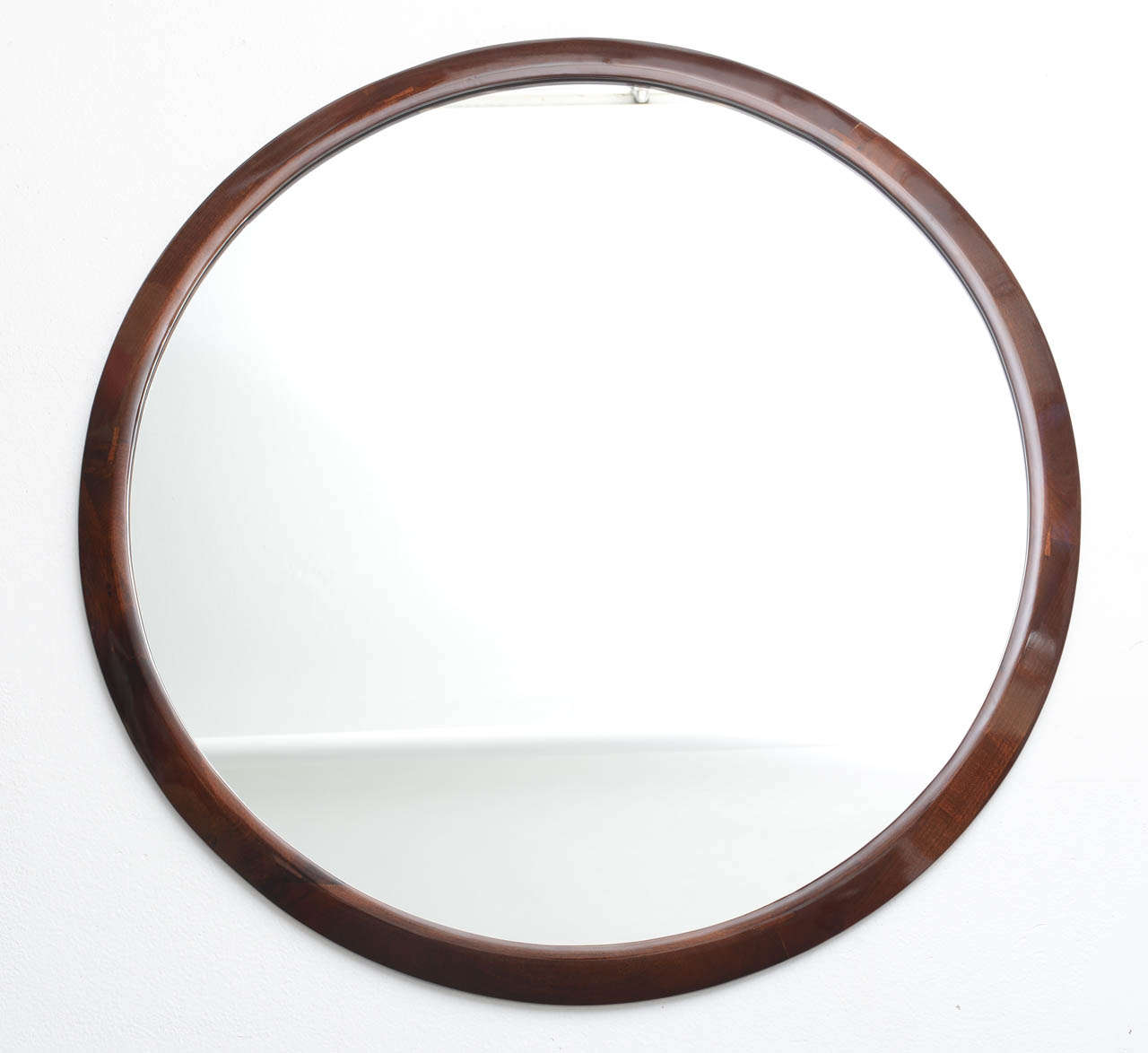 This handsome Art Deco style large-scale mirror was created in the 1930s in France. The beveled-frame is in mahogany wood with a clear varnish which catches the light and gives the piece great movement.

Please feel free to contact us directly for