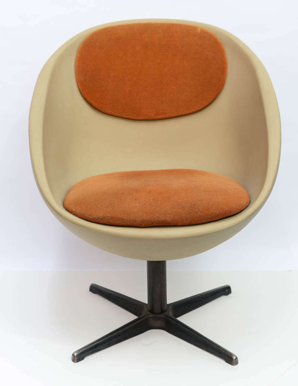 This extremely comfortable and sturdy ball/egg style in earth tones would easily complement a mid-century modern decor.  Chair of unknown origin but clearly manufactured in the 1960s.  Fabric upholstery is original and chair swivels.
