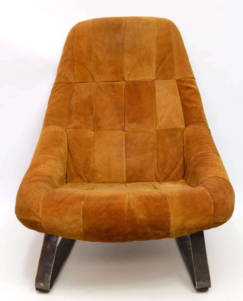 The suede upholstery and space-age contours might make this the most comfortable chair you've ever sat in.  Beautiful stitched suede and heavy metal legs make this a substantial and inviting feature in a room.  Origin is believed to be Brazil. 