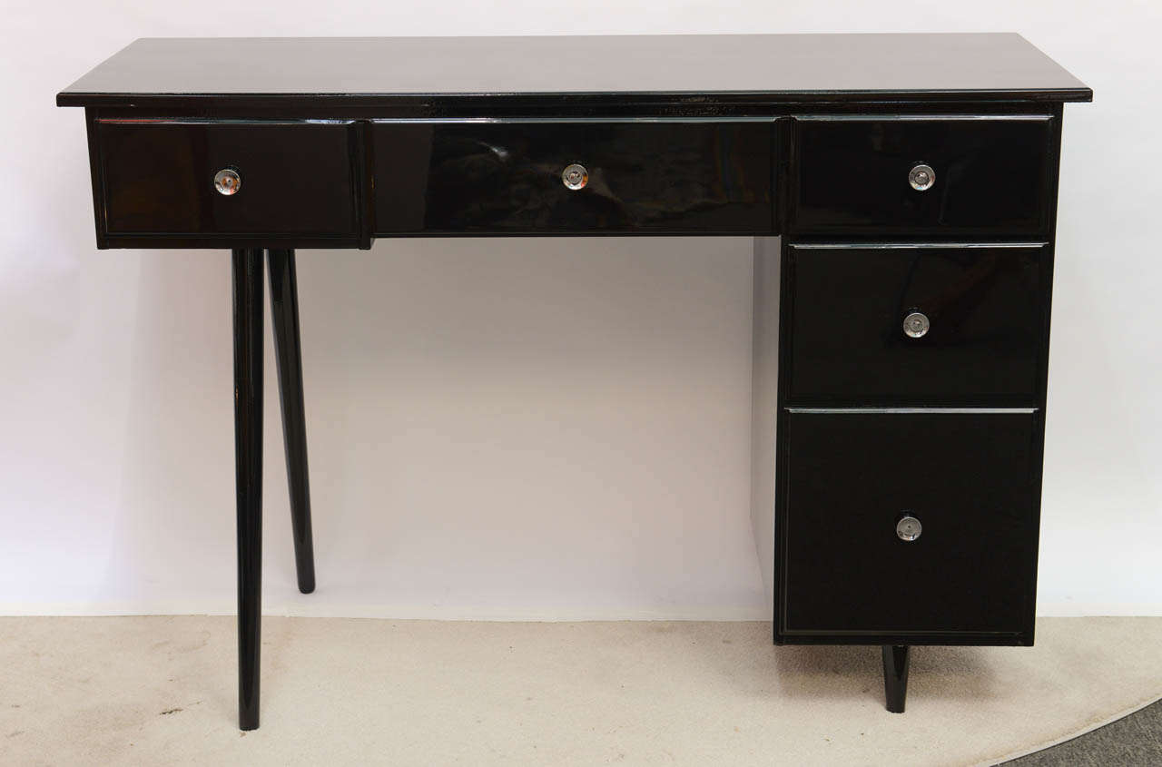 This is a perfect petite student desk or small vanity (with plenty of drawers) done in the style of Paul McCobb.  Desk has been expertly refinished in high gloss black lacquer.  The original drawer pulls included are freshly rechromed.
