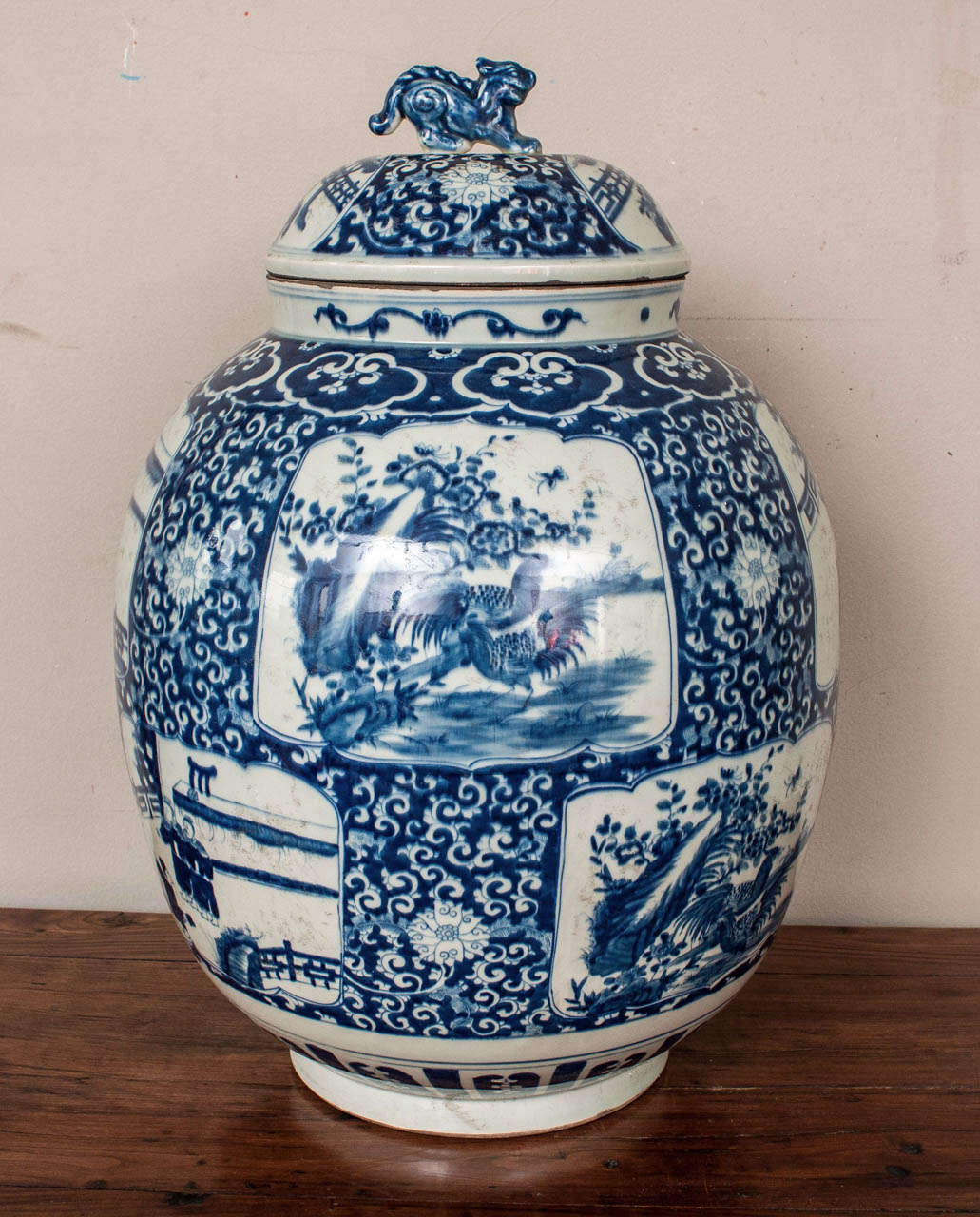 Striking pair of blue and white porcelain temple jars with lids portraying traditional landscape and figural scenes.