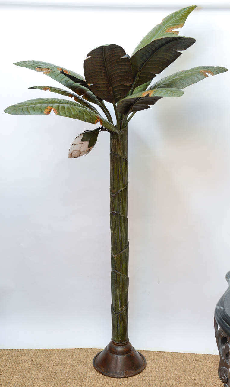 A beautiful painted metal sculptural palm tree. This tree easily disassembles for transport.