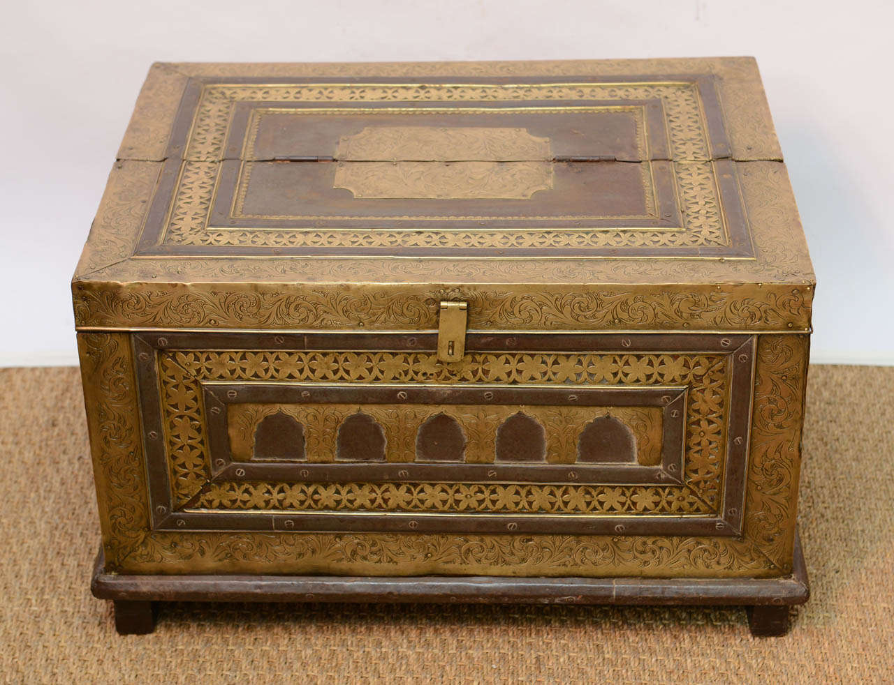 Original Antique 19th century large Moroccan chest. This large and sturdy wood chest  is adorned with very detailed repousse Brass all around. The workmanship is extraordinary. Brass handles at each side. The top opens half way. This chest stands on