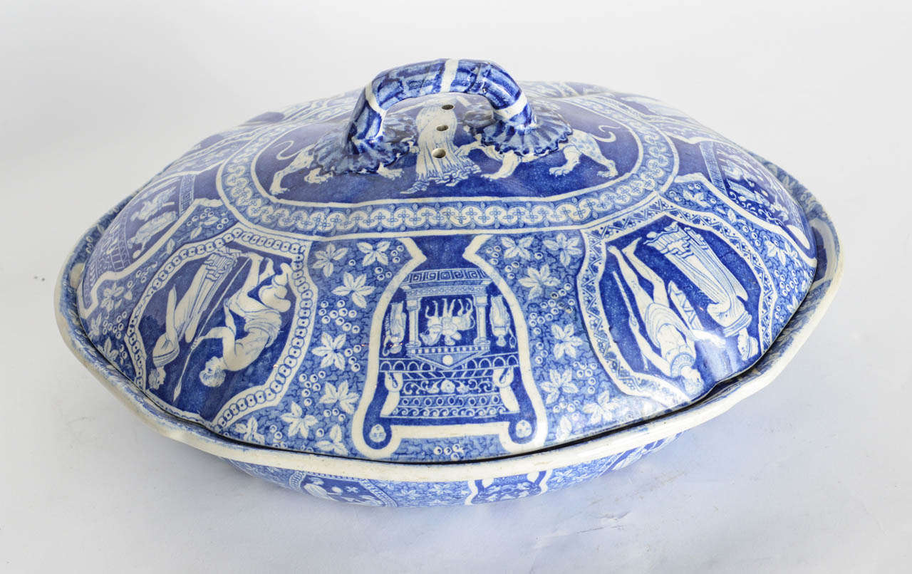 The lid and bowl overall decorated in ancient Greek motifs, the bowl segmented into four sections.