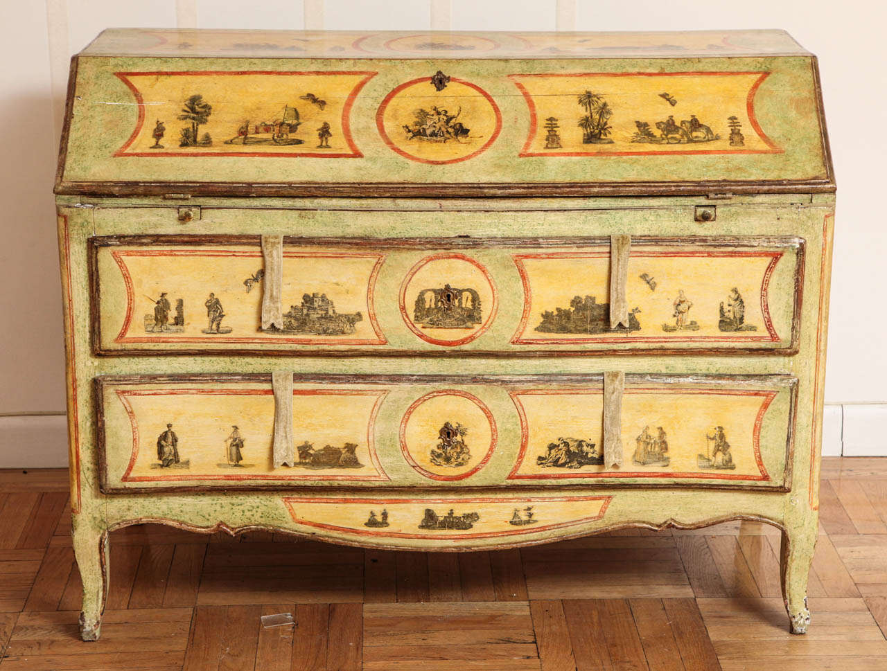A 19th Century Painted and Decoupage Secretary
Italian Polychrome and Decoupage Bureau, the drop-front opening to a variety of drawers and cubbyholes, over two long drawers, raised on cabriole legs, the whole with decoupage accents of various