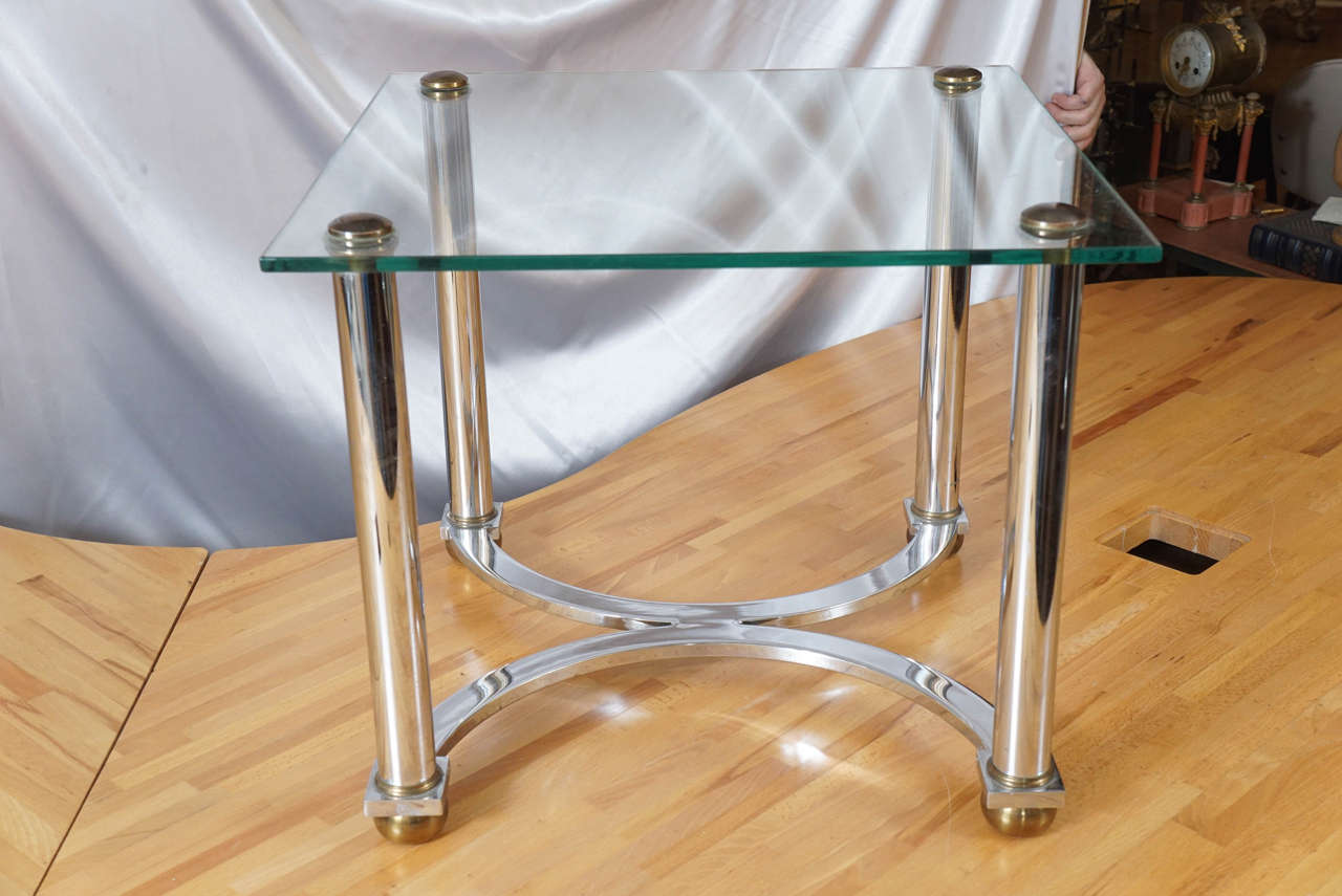A Mid-Century glass and chrome side table or cocktail table.