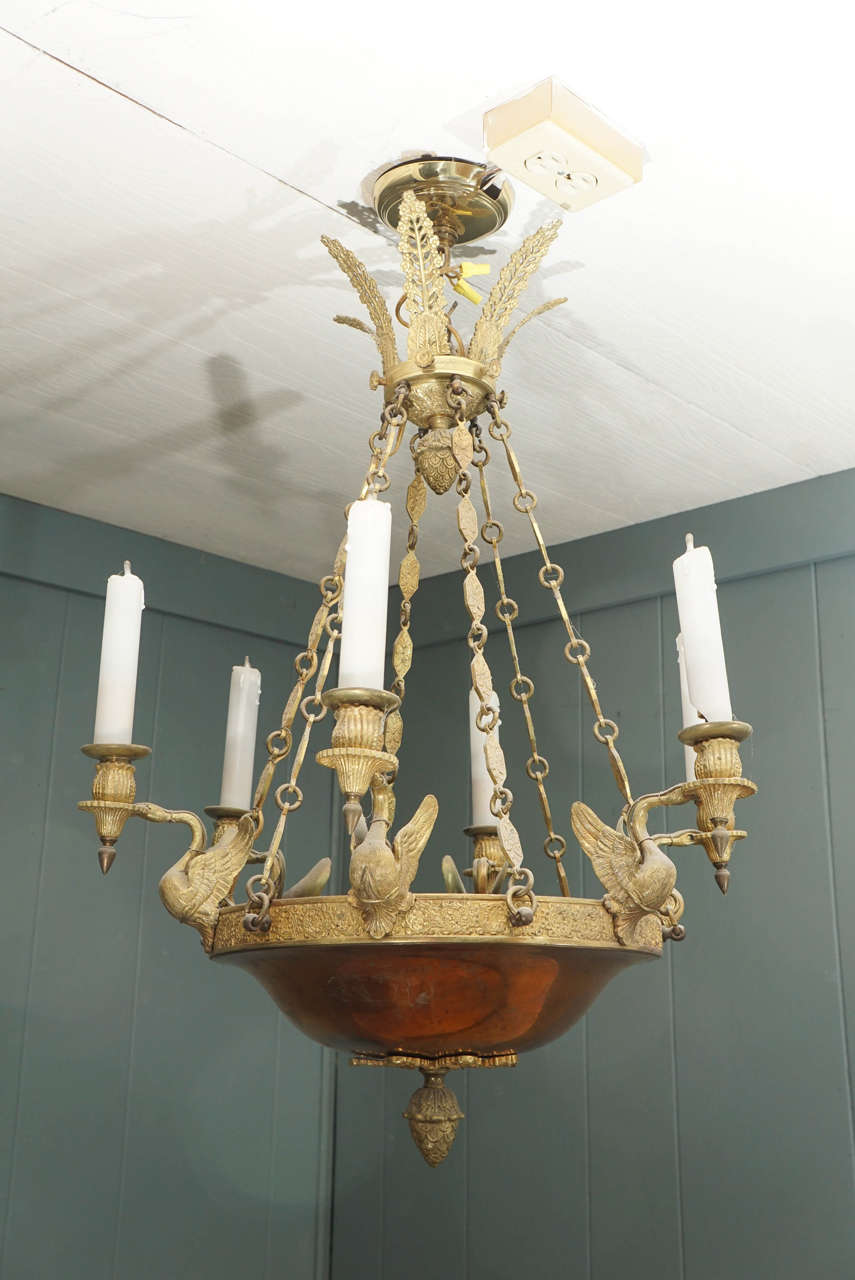 A French Empire style chandelier with bronze swan accents.