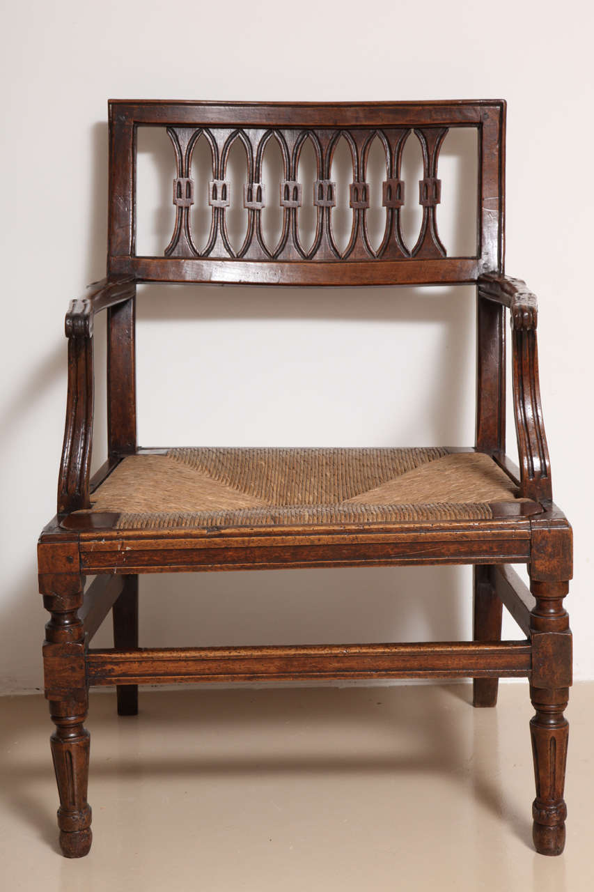 Scaled for a robber baron's villa. Attractive design with rustic rush seats and refined carving and richly-hued timber.