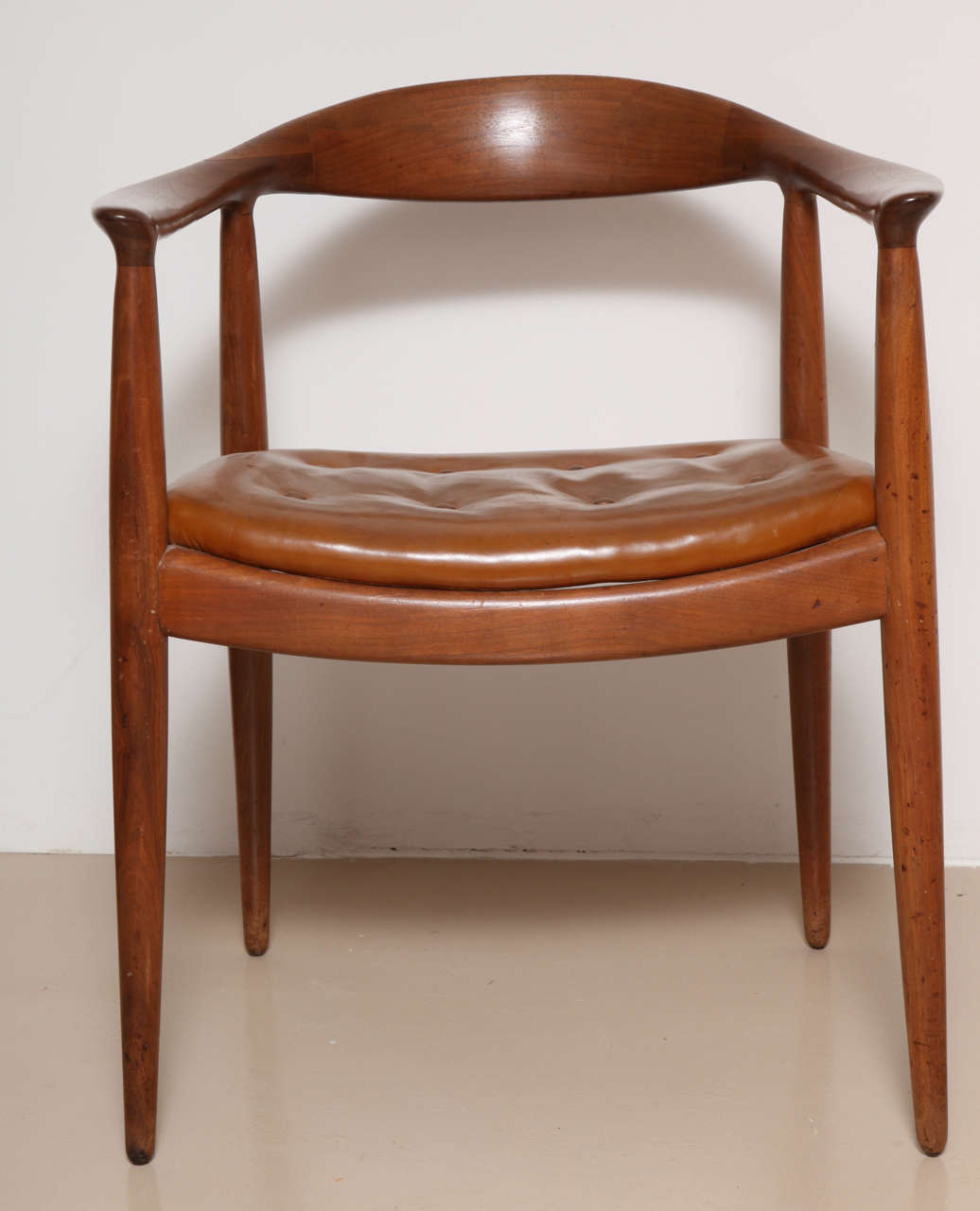 Danish Midcentury "The Chair" after Hans Wegner. In teak and original tan leather.