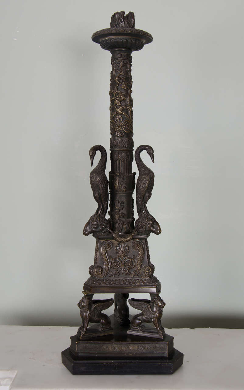 Probably English, 19th century, after a design by Giovanni Battista Piranesi.
Similar to the Newdigate candelabrum in the collection of the Ashmolean Museum, the columns with three cast herons above ram's heads and pendant swags, on triangular