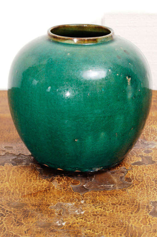 Stunning emerald green glaze round jar exhibits the crazing of age.