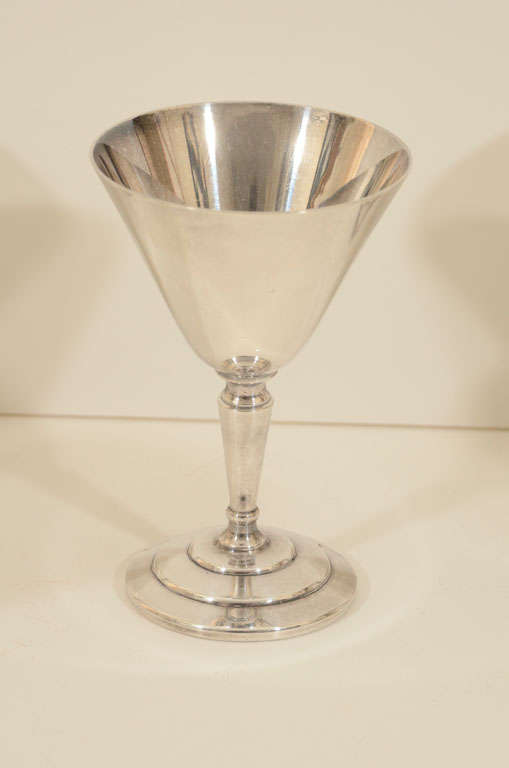Silver plated cocktail glasses in classic Art Deco design. Possibly attributed to Keith Murray as it's similar in design to his 1 pint cocktail shaker. Signed Mappin & Webb Ltd.