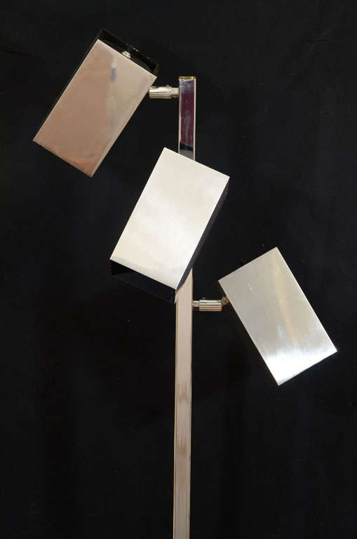 A chrome lamp with three adjustable rectangular lights. The pole stands almost 5ft tall and each globe measures 7