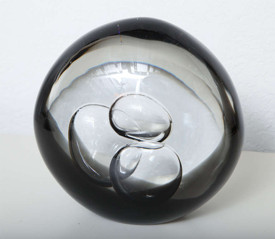 Three large bubbles overlap inside this fascinating Livio Seguso glass sculpture. Especially captivating when lit from behind or below, this smoky grey 70's piece has an etched signature on the underside.