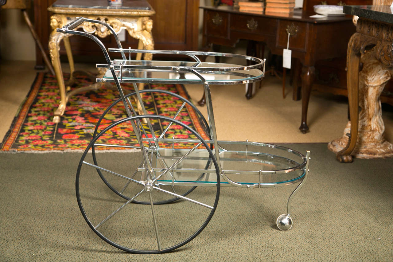 An Italian chromed metal and glass bar cart.