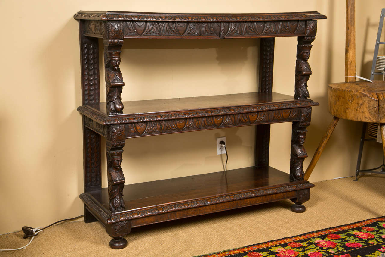 An English carved oak three-tiered server.