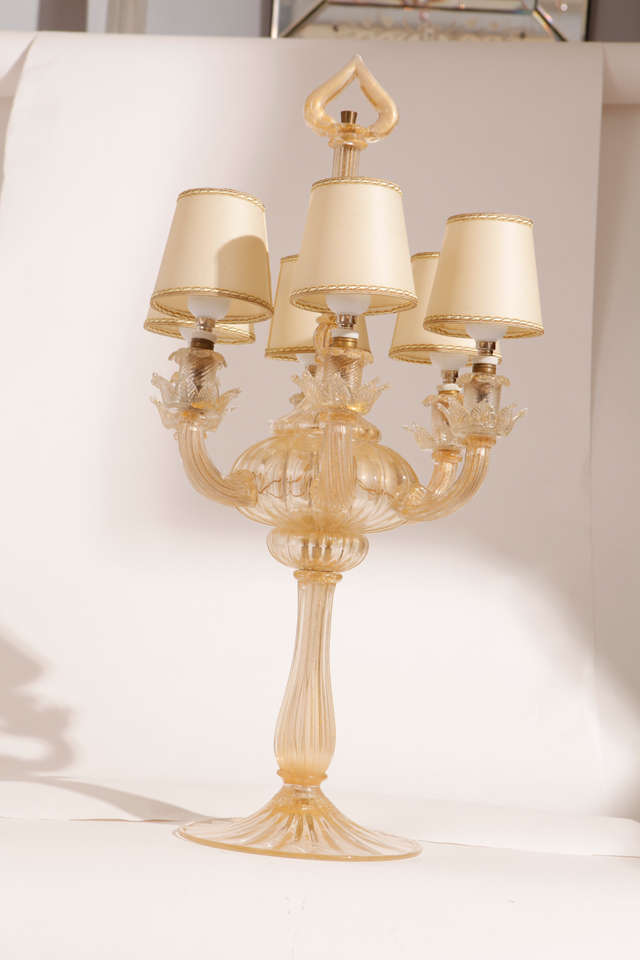 Mid Century Seguso Murano Glass  table lamp blown with gold Leaf inside that give warm color at the transparence of the glass , six arms and bulbs with new shades .
The lantern design has been interpreted in this in a modern key typical of the