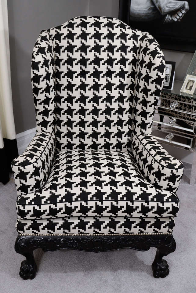 Ball and claw houndstooth English wing chair with nickel nailheads. A sophisticated turn of the century, antique wing chair that has been reupholstered in black and white houndtooth fabric. It is in excellent condition and available for purchase as