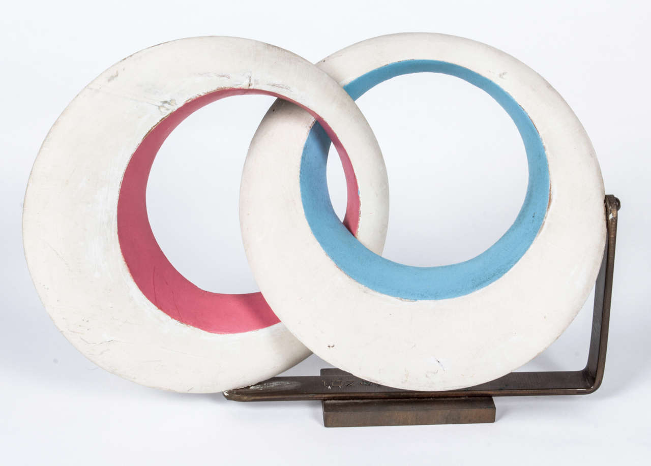 RAYMOND BARGER  (1906-2001)  USA

Sculpture c. 1955

Polychrome contoured wood of interlocking circular forms in white, blue and pink on a bronze base.

Signed: RB (artist initials), USA, Z0I

H: 8 1/2”  x  L: 12 ¾” x D: 8

Raymond