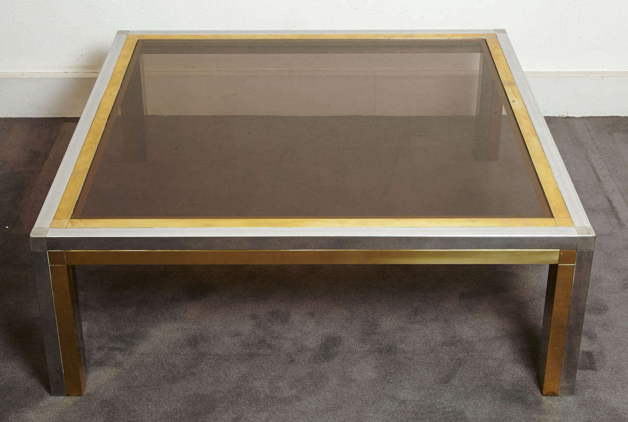 Square coffee table, France, 1970's.
Chromed steel and gilt brass structure, smoked glass.