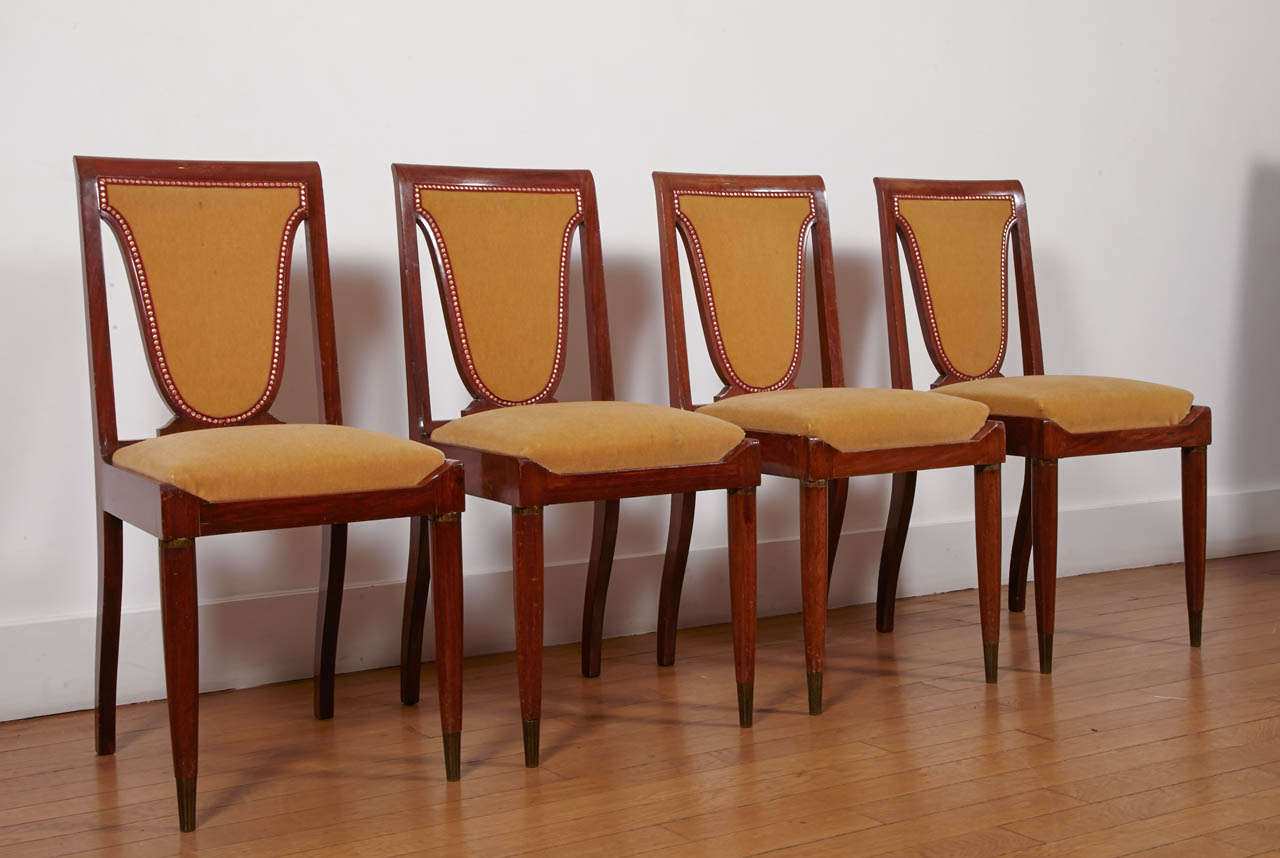 Rare set of eight mahogany chairs, 1930's, by Christian Krass (1868-1957).  
Forefeet with upper fluted rings and sabots, Curved saber backfeet
Original 